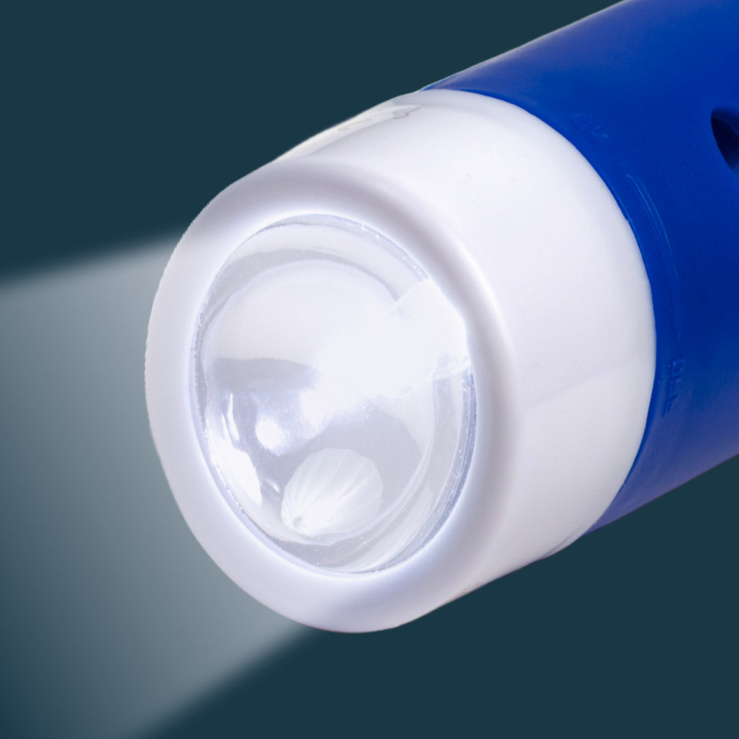 Close-up of a blue flashlight on a dark background