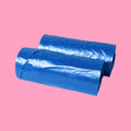 Two rolls of blue plastic sheeting on a pink background