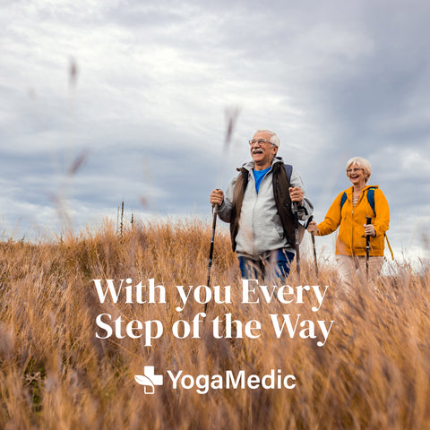 Old couple on a hike, with YogaMedic's medical equipment assisting them.