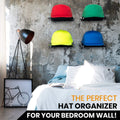 Colorful hats on Boxy Concepts' wall-mounted organizer and hat display shelves in a bedroom with a lamp and bed.