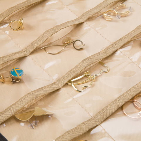 Collection of gold earrings on a quilted beige Boxy Concepts' jewelry case