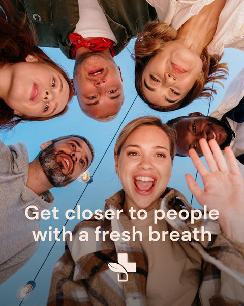 People standing in a circle with a blue sky background and text 'Get closer to people with a fresh breath'.