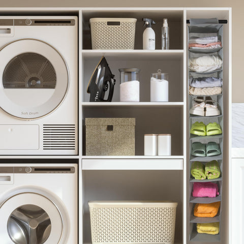  laundry room with washing machine, dryer, and organized shelves with cleaning supplies and folded clothes on Boxy Concepts' foldable, closet shelves.