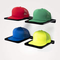Four colorful caps (red, green, blue, yellow) on black display racks by Boxy Concepts, against a white background