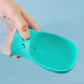 MalsiPree's turquoise pet water bottle with attached bowl, held by a hand against a light blue background