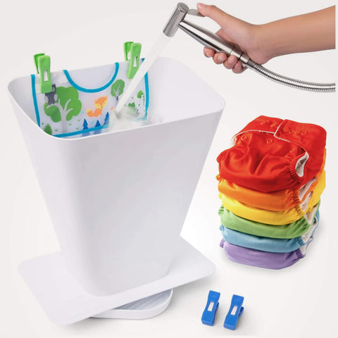 Stack of colorful diapers next to SimplyImagine's anti-spray cloth diaper washing system with clothespins and a hand holding a shower head.